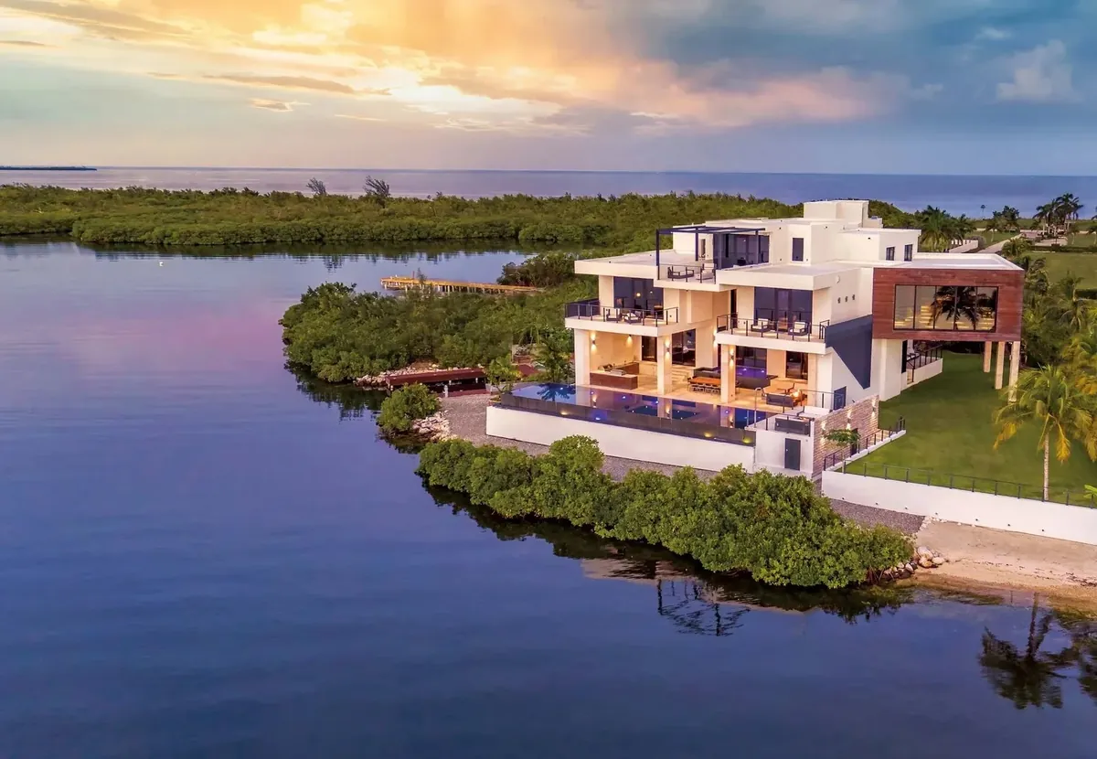 Aerial view at dusk of Serenity House, a waterfront home in Grand Cayman inspected by WestPoint